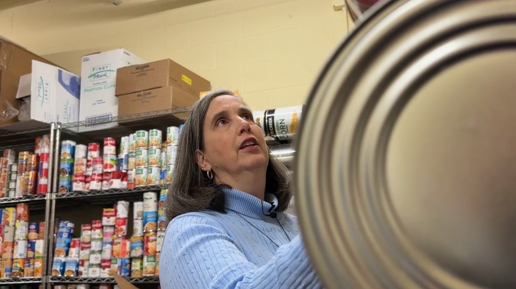 Jan Kelly looking at items in the food pantry at Samaritan Ministries.